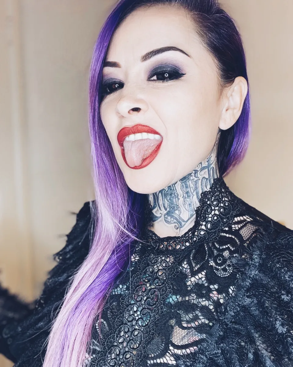 Cybil Souza with violet hair, laughing