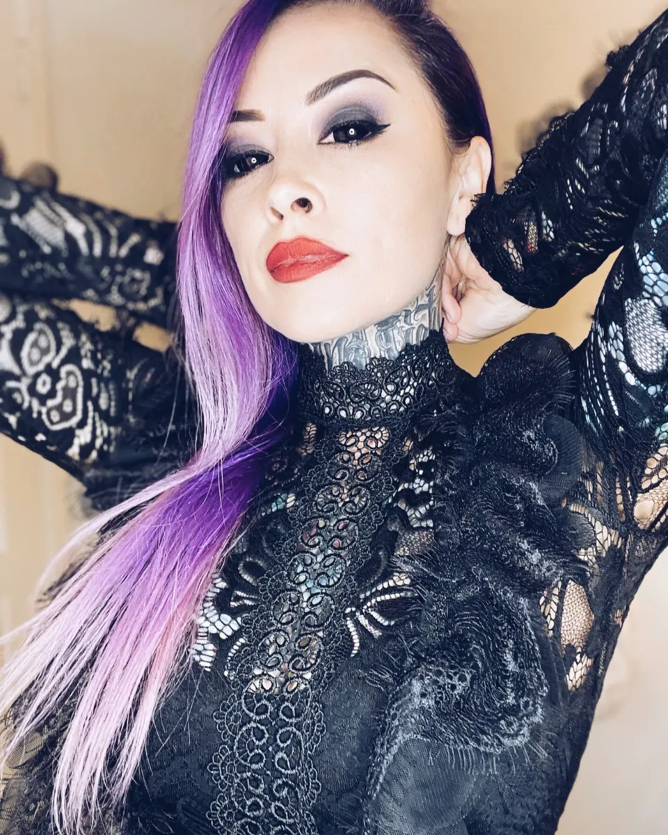 Cybil Souza, hypnotherapist, in black lace with violet hair